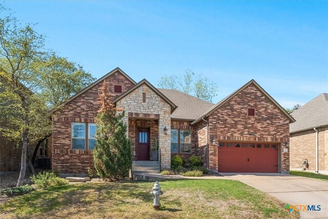 9550 Savannah Ridge Dr Unit 11, Austin, TX 78726 - view of front of home with concrete driveway, a front yard, and brick siding