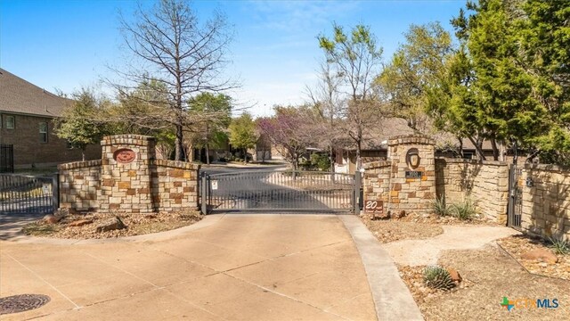 9550 Savannah Ridge Dr Unit 11, Austin, TX 78726 - view of concrete road with a gate and a gated entry