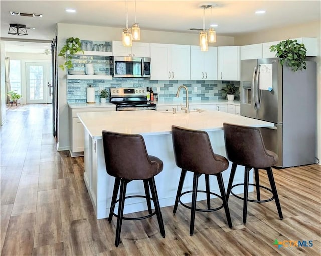 4770 Fm 2808, Kempner, TX 76539 - kitchen featuring appliances with stainless steel finishes, a sink, light countertops, white cabinetry, and recessed lighting