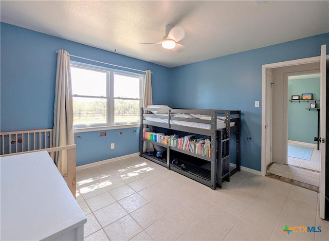 4770 Fm 2808, Kempner, TX 76539 - bedroom featuring tile patterned floors, baseboards, and a ceiling fan