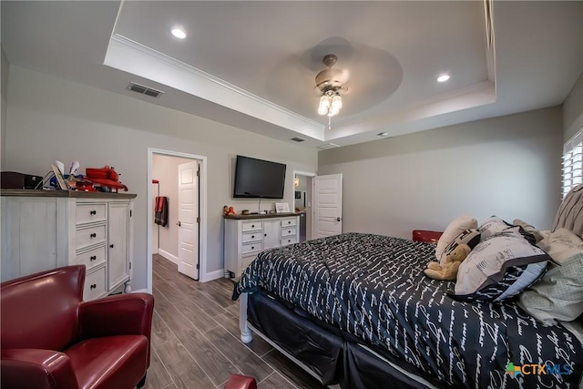 bedroom with a tray ceiling, ceiling fan, and crown molding