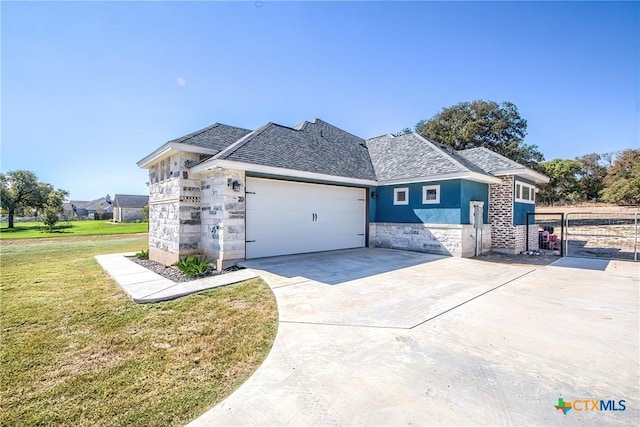 view of front of home with a front yard and a garage