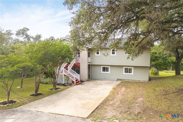 1215 Amanda, Canyon Lake, TX 78133 - view of front facade featuring driveway, a front yard, and stairway