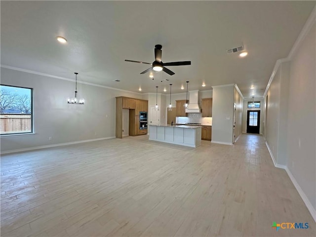 unfurnished living room with ornamental molding, ceiling fan with notable chandelier, and light hardwood / wood-style flooring