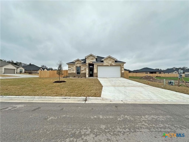 view of front of house with a garage and a front yard