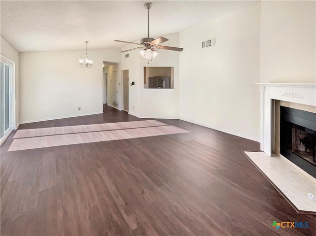 unfurnished living room with ceiling fan with notable chandelier, dark hardwood / wood-style flooring, lofted ceiling, and a textured ceiling