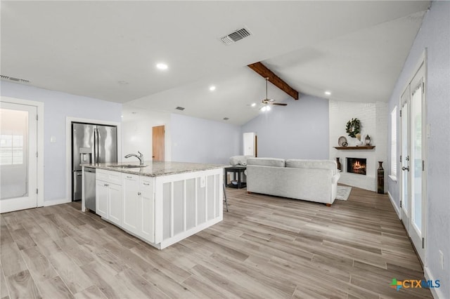 8704 Trailridge Dr, Temple, TX 76502 - kitchen featuring open floor plan, light wood-style flooring, white cabinetry, light stone counters, and recessed lighting