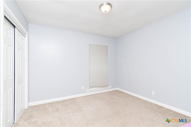 2206 Grandon Cir, Killeen, TX 76541 - unfurnished bedroom featuring baseboards, a closet, and light carpet