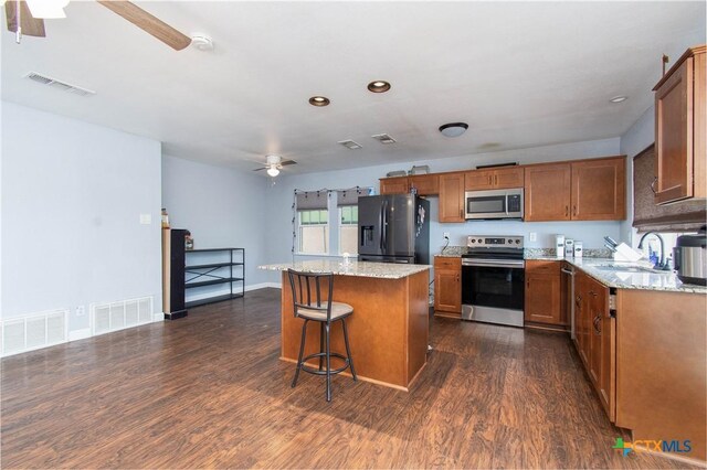 2206 Grandon Cir, Killeen, TX 76541 - kitchen with brown cabinets, visible vents, ceiling fan, and appliances with stainless steel finishes
