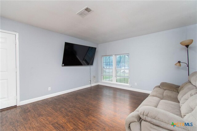 2206 Grandon Cir, Killeen, TX 76541 - unfurnished living room featuring baseboards, visible vents, and wood finished floors
