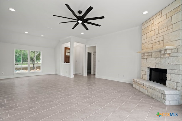 unfurnished living room featuring a stone fireplace, ceiling fan, and crown molding