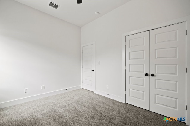 unfurnished bedroom featuring carpet flooring and a closet