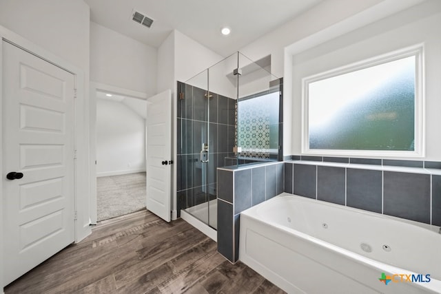 bathroom with wood-type flooring and separate shower and tub