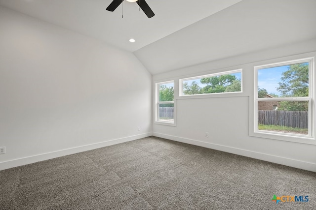 unfurnished room with lofted ceiling, carpet flooring, and ceiling fan