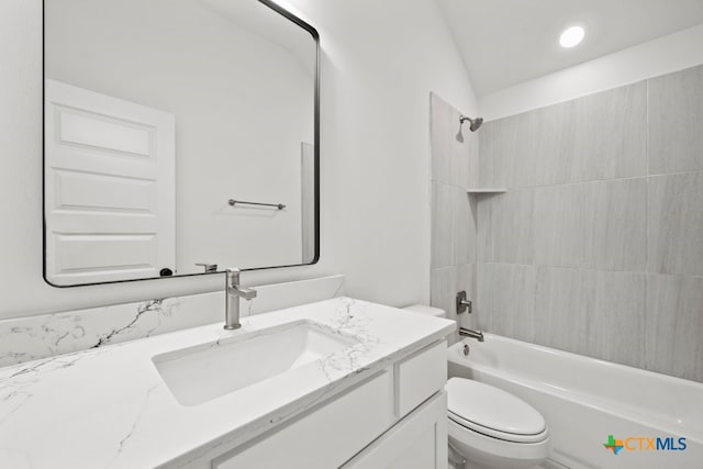 full bathroom with vanity, toilet, vaulted ceiling, and tiled shower / bath combo