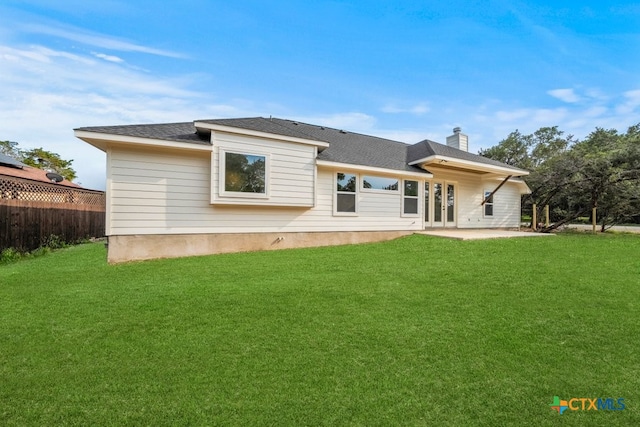 back of house featuring a patio and a yard