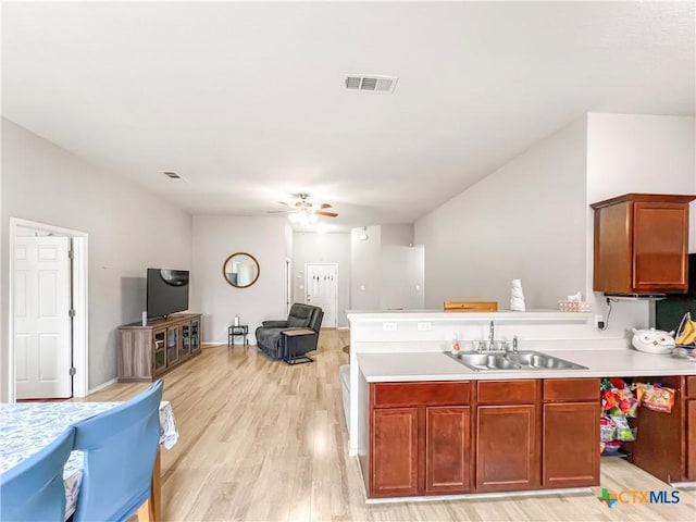 144 Calcite Ln, Jarrell, TX 76537 - kitchen featuring a sink, open floor plan, ceiling fan, light wood-type flooring, and light countertops