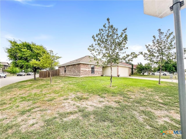 144 Calcite Ln, Jarrell, TX 76537 - view of front of home featuring concrete driveway, a garage, and brick siding