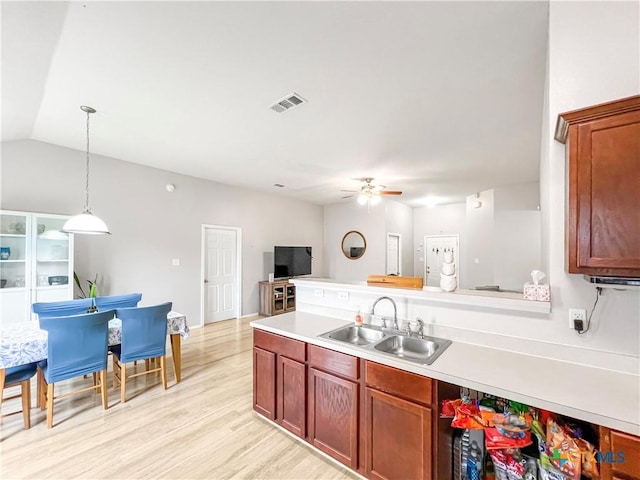 144 Calcite Ln, Jarrell, TX 76537 - kitchen featuring a sink, ceiling fan, light countertops, decorative light fixtures, and light wood finished floors