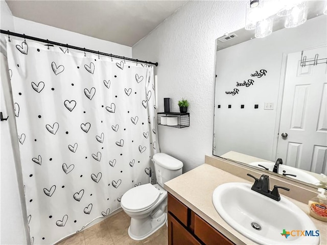 144 Calcite Ln, Jarrell, TX 76537 - bathroom with toilet, a textured wall, vanity, a shower with shower curtain, and tile patterned flooring