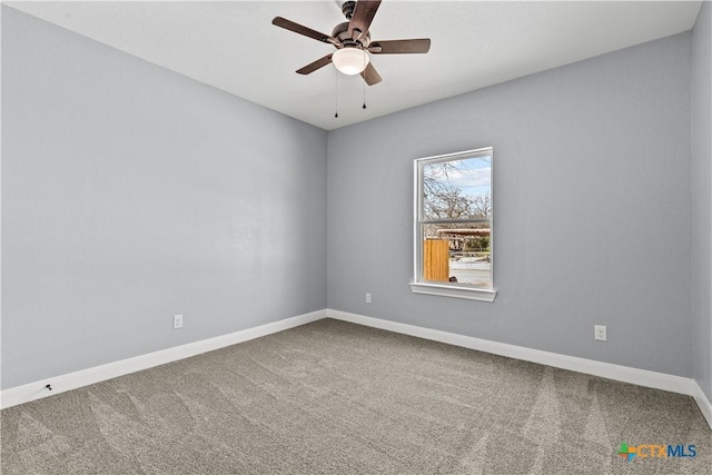 unfurnished room with carpet, a ceiling fan, and baseboards