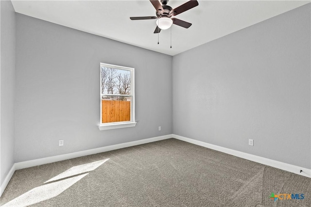 empty room featuring carpet floors, baseboards, and a ceiling fan