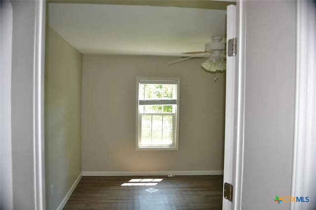 empty room featuring dark hardwood / wood-style flooring and ceiling fan