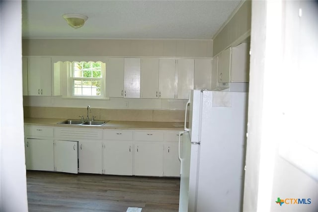 kitchen with white cabinets and white refrigerator