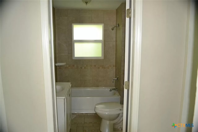 full bathroom featuring tile patterned flooring, vanity, toilet, and tiled shower / bath