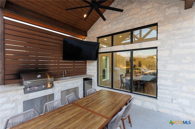 view of patio / terrace with a grill, ceiling fan, sink, and exterior kitchen