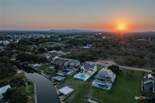 aerial view at dusk with a water view