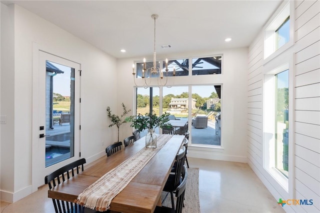 dining room featuring a healthy amount of sunlight and an inviting chandelier