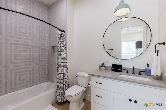 full bathroom with vanity, shower / bath combination with curtain, and toilet