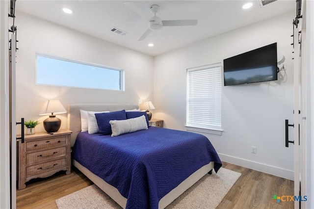 bedroom featuring hardwood / wood-style flooring and ceiling fan