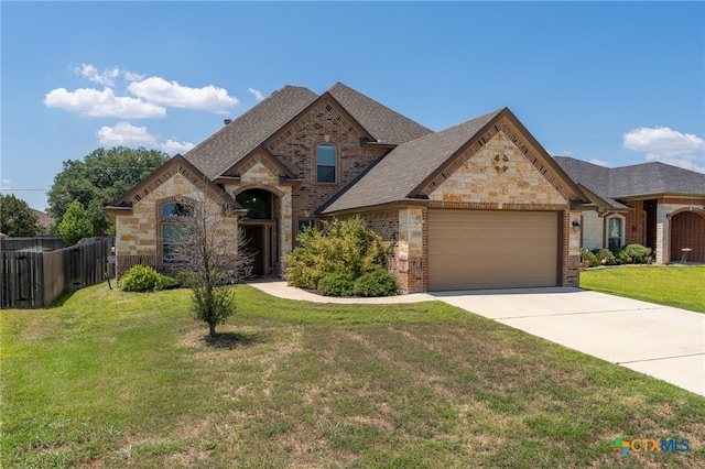 view of front of house featuring a garage and a front yard