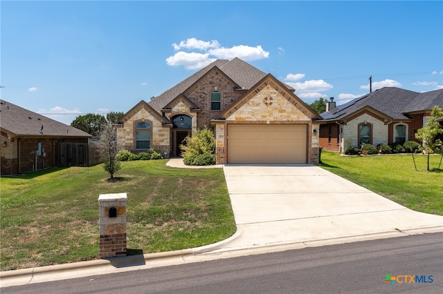 view of front facade featuring a garage and a front yard