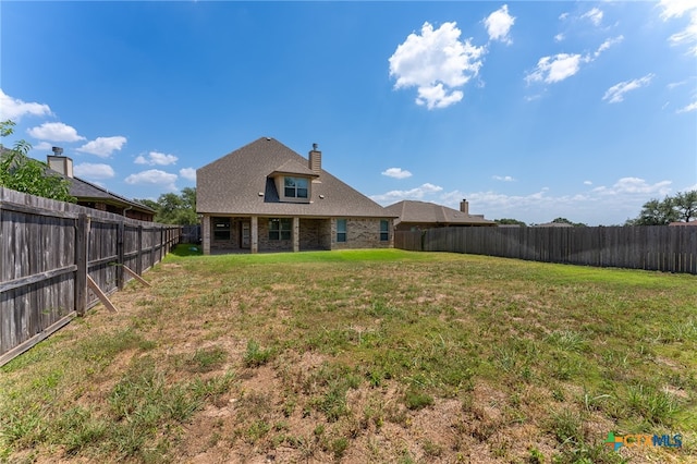 back of property featuring a lawn