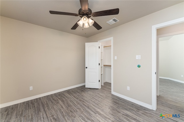 unfurnished bedroom featuring hardwood / wood-style floors and ceiling fan