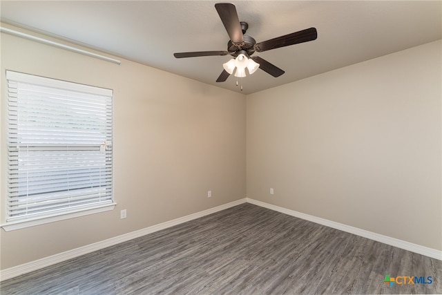 empty room with ceiling fan and dark hardwood / wood-style floors