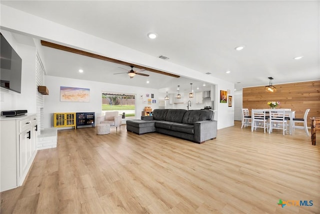 921 Indian Trl, Harker Heights, TX 76548 - living area featuring a ceiling fan, light wood-style floors, recessed lighting, wood walls, and beam ceiling