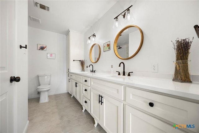 921 Indian Trl, Harker Heights, TX 76548 - bathroom featuring toilet, double vanity, and tile patterned floors
