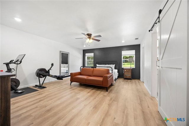 921 Indian Trl, Harker Heights, TX 76548 - bedroom featuring a barn door, light wood finished floors, baseboards, recessed lighting, and a ceiling fan