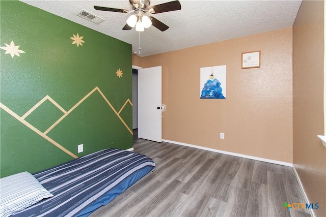 3605 Pleasing Cir, Killeen, TX 76542 - unfurnished bedroom with wood finished floors, a textured ceiling, and a ceiling fan