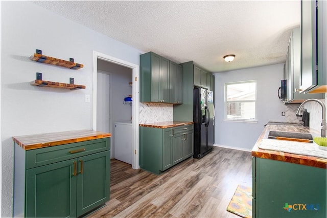 3605 Pleasing Cir, Killeen, TX 76542 - kitchen featuring black appliances, wood counters, backsplash, light wood-style flooring, and a textured ceiling