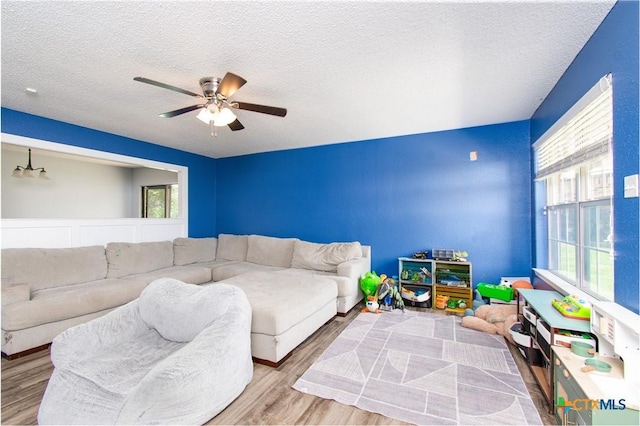 3605 Pleasing Cir, Killeen, TX 76542 - living area with wood finished floors, a ceiling fan, and a textured ceiling