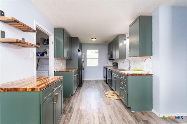 3605 Pleasing Cir, Killeen, TX 76542 - kitchen featuring wood counters, washer / dryer, green cabinetry, light wood finished floors, and appliances with stainless steel finishes