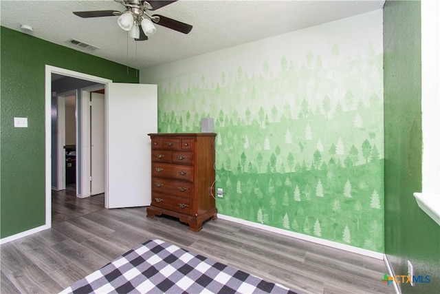 3605 Pleasing Cir, Killeen, TX 76542 - bedroom with wood finished floors, ceiling fan, and a textured ceiling