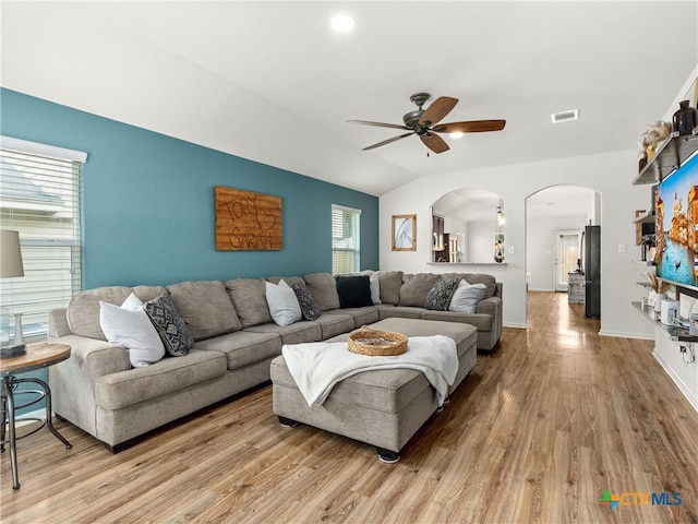 2416 Kolton St, New Braunfels, TX 78130 - living room with arched walkways, ceiling fan, light wood finished floors, and vaulted ceiling