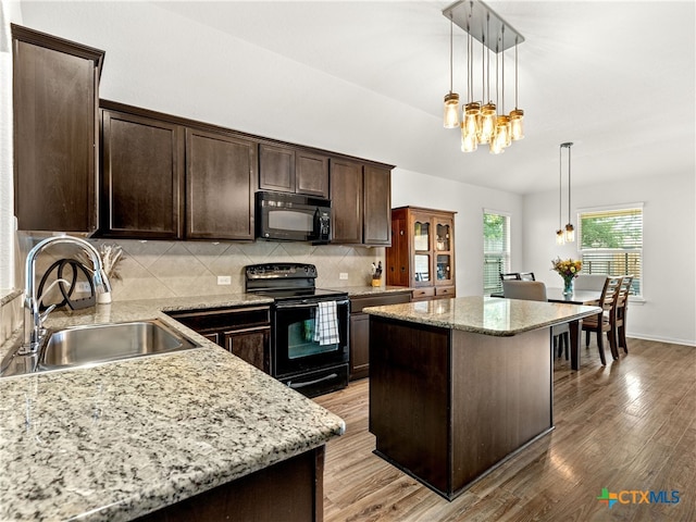 2416 Kolton St, New Braunfels, TX 78130 - kitchen featuring black appliances, dark brown cabinets, backsplash, pendant lighting, and light wood finished floors