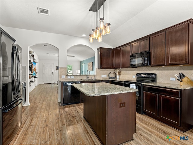 2416 Kolton St, New Braunfels, TX 78130 - kitchen featuring black appliances, dark brown cabinetry, light wood-style flooring, a center island, and lofted ceiling